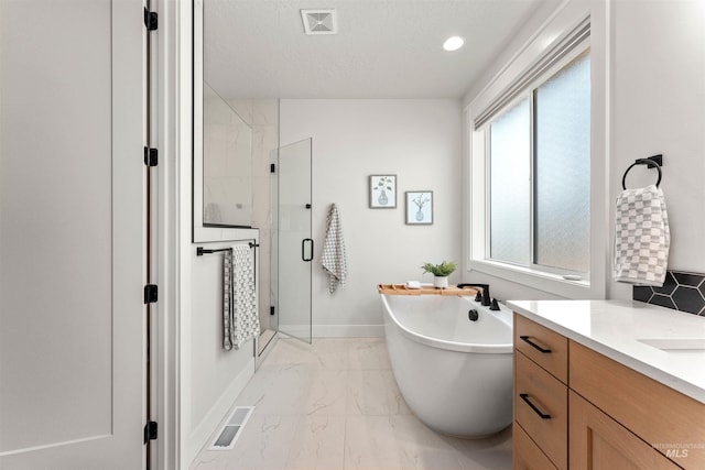 2255 N Sugar Loop Ave, Star, ID 83669 - bathroom with marble finish floors, a stall shower, a freestanding bath, and vanity