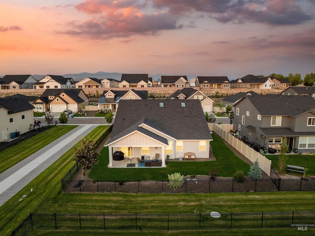 2255 N Sugar Loop Ave, Star, ID 83669 - back of house at dusk with a residential view, a fenced backyard, and a patio