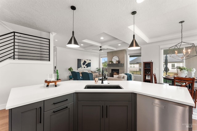 2255 N Sugar Loop Ave, Star, ID 83669 - kitchen with light countertops, open floor plan, a chandelier, a large fireplace, and gray cabinets