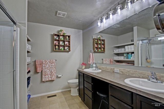 bathroom featuring toilet, tasteful backsplash, a sink, and tiled shower