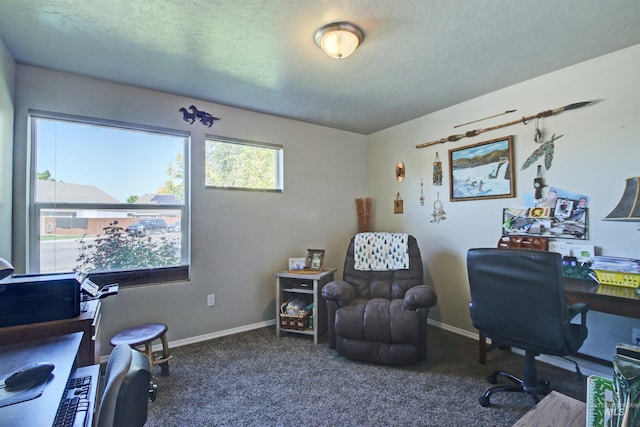 office area with baseboards, dark colored carpet, and a textured ceiling