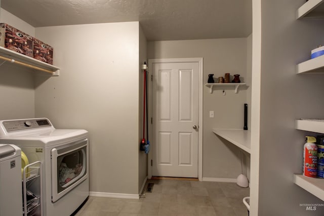 laundry area featuring laundry area, baseboards, and washer and dryer