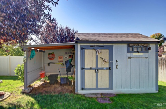 view of shed featuring fence