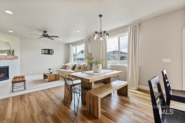 2065 Sombrero Ave, Middleton, ID 83644 - dining room featuring light wood-style flooring, a fireplace, recessed lighting, and a ceiling fan