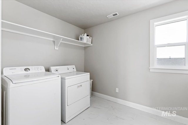2065 Sombrero Ave, Middleton, ID 83644 - laundry area featuring washing machine and clothes dryer and light marble finish flooring
