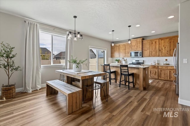 2065 Sombrero Ave, Middleton, ID 83644 - dining area featuring wood finished floors, recessed lighting, and a chandelier