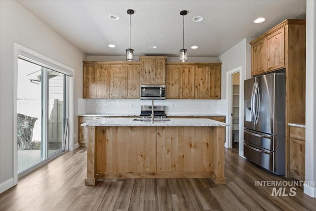 2065 Sombrero Ave, Middleton, ID 83644 - kitchen with stainless steel appliances, dark wood-type flooring, a kitchen island with sink, backsplash, and recessed lighting