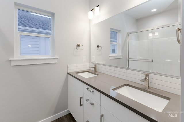 6760 S Cheyenne Ave, Boise, ID 83709 - full bathroom featuring double vanity, a sink, an enclosed shower, and backsplash