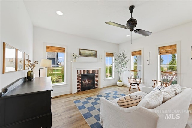 living area featuring a wealth of natural light, recessed lighting, light wood-style flooring, and a ceiling fan