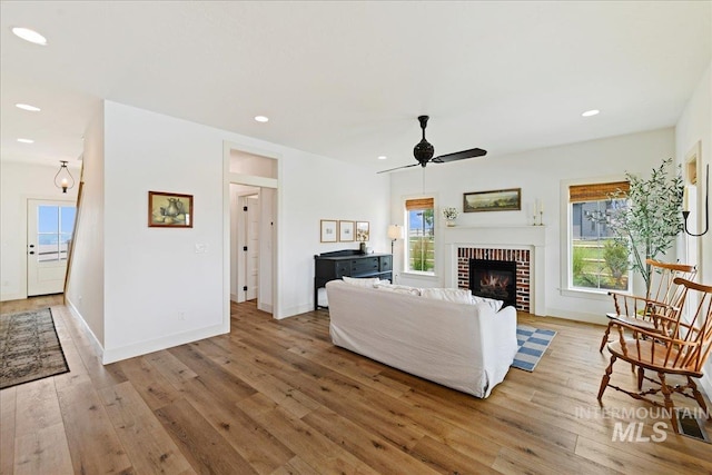 living room with recessed lighting, plenty of natural light, and light wood-style floors