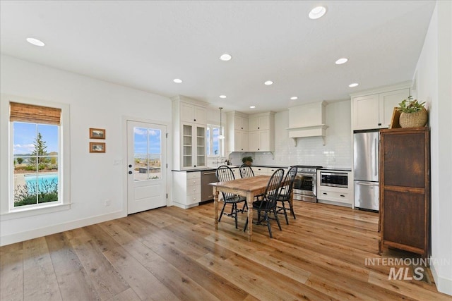 dining room with plenty of natural light, recessed lighting, and light wood-type flooring