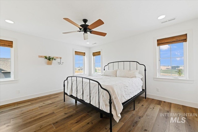 bedroom with visible vents, ceiling fan, baseboards, recessed lighting, and wood-type flooring