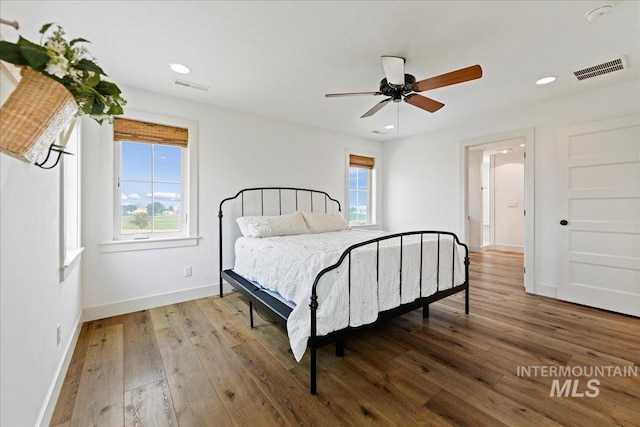 bedroom with visible vents, recessed lighting, baseboards, and hardwood / wood-style floors