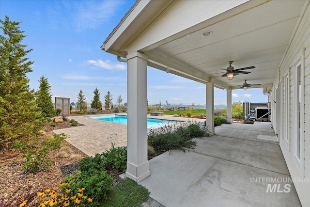 view of patio / terrace with an outdoor pool and a ceiling fan