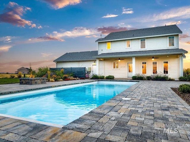 pool with a patio area and ceiling fan