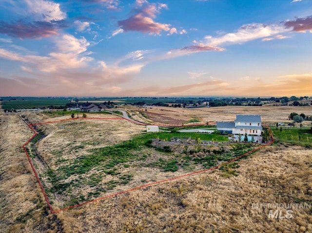 birds eye view of property with a rural view