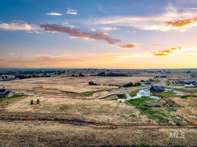 aerial view at dusk featuring a rural view