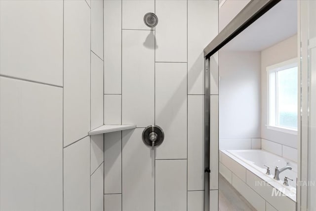 bathroom featuring shower with separate bathtub