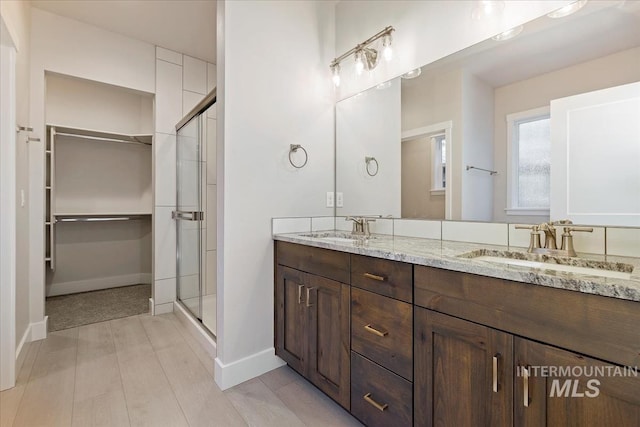 bathroom with an enclosed shower and vanity