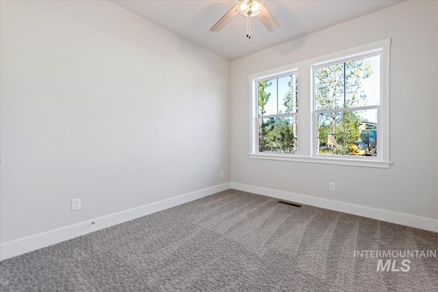 spare room featuring vaulted ceiling, carpet, and ceiling fan