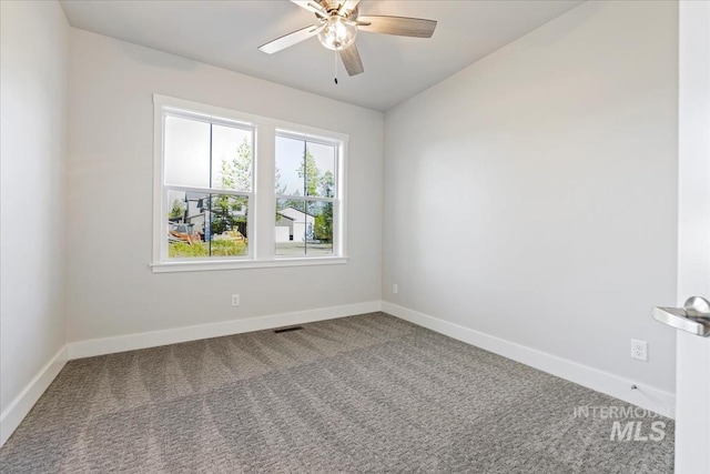 carpeted spare room with ceiling fan