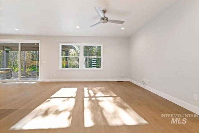 empty room featuring ceiling fan and light hardwood / wood-style floors