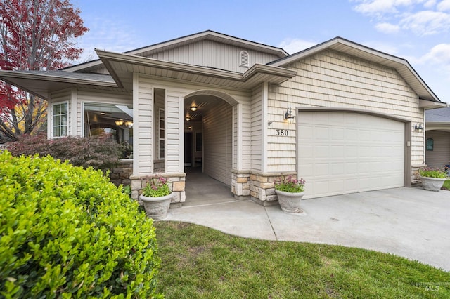 380 S Golden Eagle Ln, Eagle, ID 83616 - view of front of home featuring driveway, a garage, and stone siding