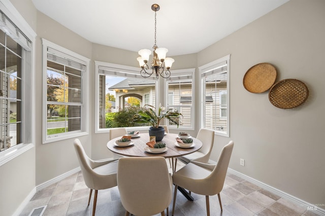 380 S Golden Eagle Ln, Eagle, ID 83616 - dining room featuring a chandelier and baseboards
