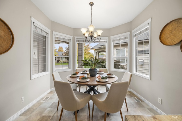 380 S Golden Eagle Ln, Eagle, ID 83616 - dining room with a chandelier and light stone finish floors