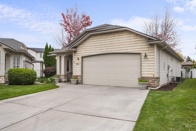 380 S Golden Eagle Ln, Eagle, ID 83616 - view of front of home featuring driveway, an attached garage, stone siding, and a front lawn
