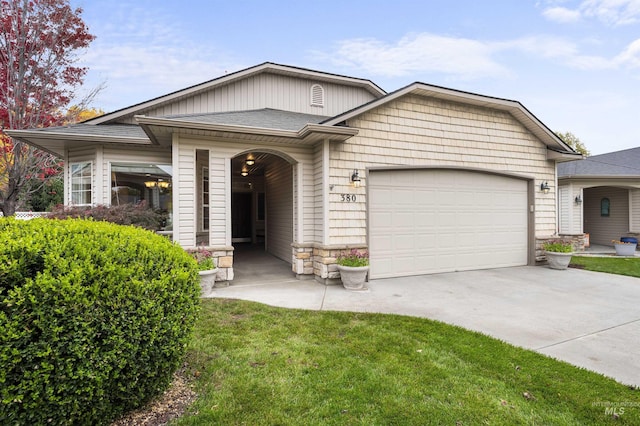 380 S Golden Eagle Ln, Eagle, ID 83616 - view of front of house featuring driveway, a garage, and stone siding