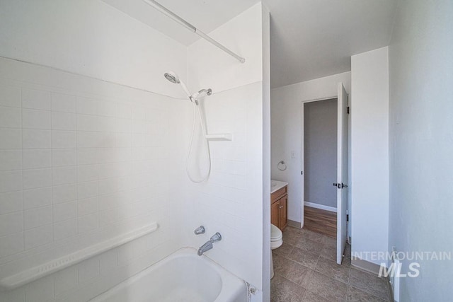 full bathroom featuring vanity, bathing tub / shower combination, and toilet