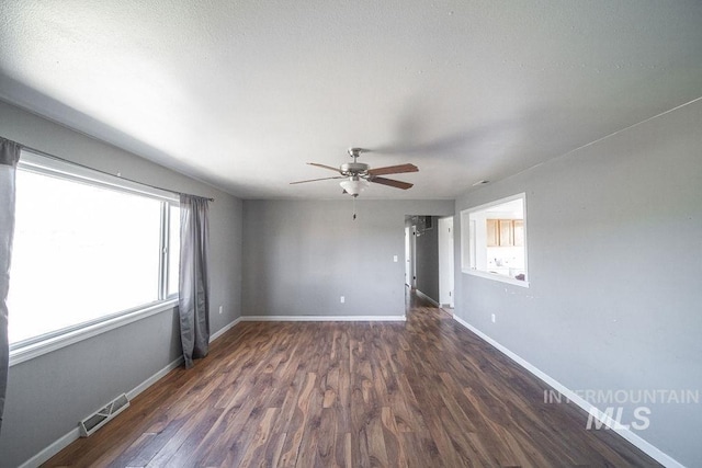 unfurnished room with dark hardwood / wood-style floors and ceiling fan