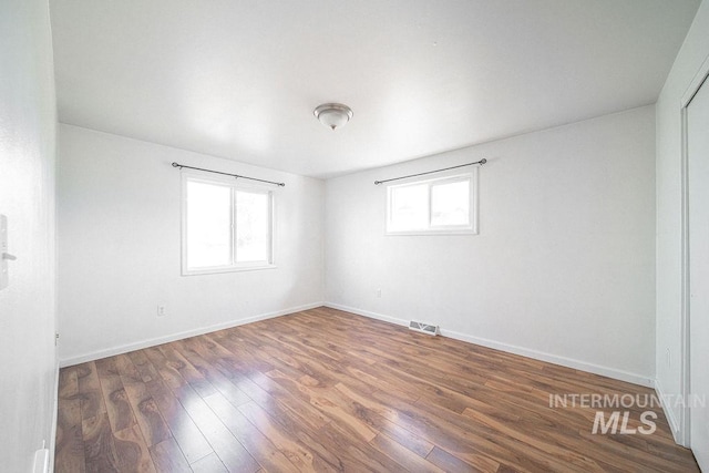 spare room featuring dark hardwood / wood-style floors