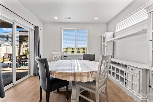 dining room featuring light wood-style floors, healthy amount of natural light, and recessed lighting