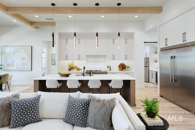 kitchen featuring beamed ceiling, decorative light fixtures, stainless steel built in fridge, and stainless steel refrigerator