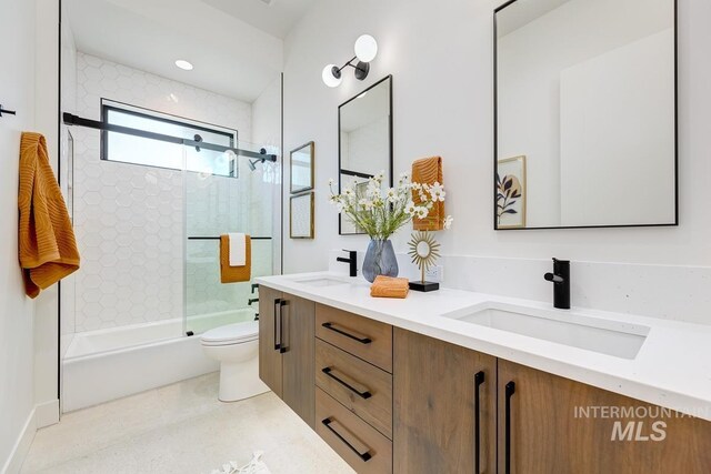 full bathroom with vanity, toilet, and enclosed tub / shower combo