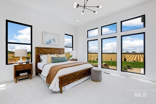 carpeted bedroom featuring a chandelier