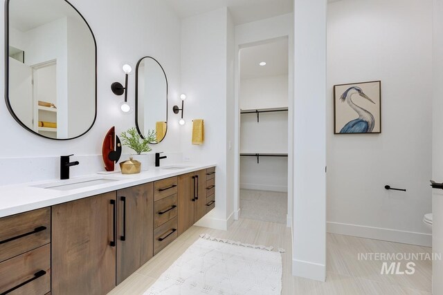 bathroom featuring tile patterned flooring, vanity, and toilet