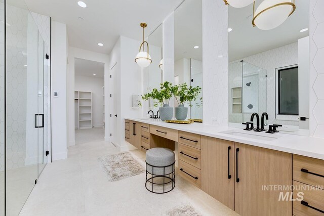 bathroom featuring vanity and a shower with shower door