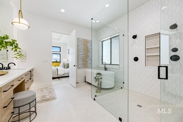 bathroom with vanity and separate shower and tub