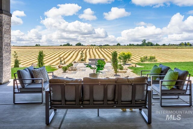 view of patio / terrace featuring an outdoor living space and a rural view