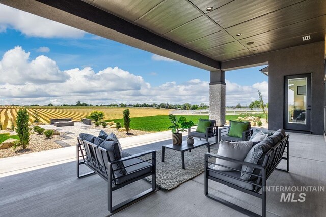 view of patio featuring an outdoor living space and a rural view