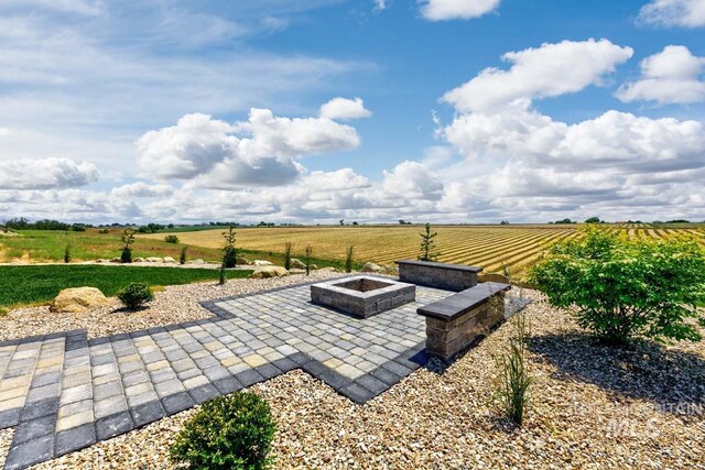 view of patio / terrace with a rural view and an outdoor fire pit