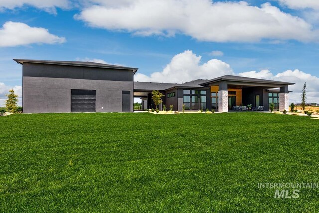 rear view of house featuring a yard