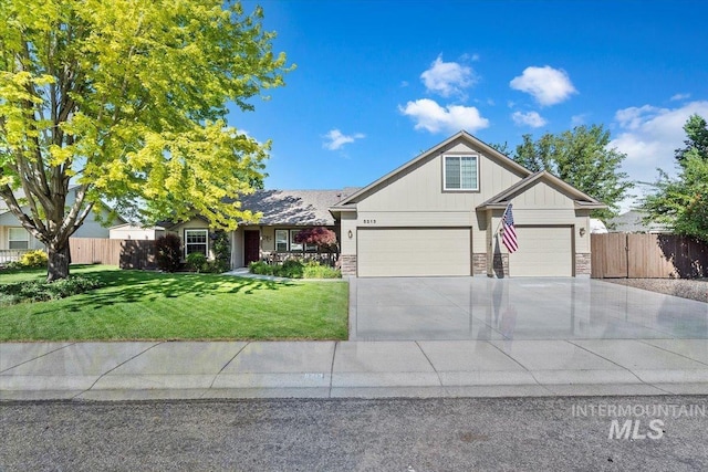 5213 S Walcott Ave, Boise, ID 83709 - view of front facade featuring driveway, board and batten siding, stone siding, and a garage
