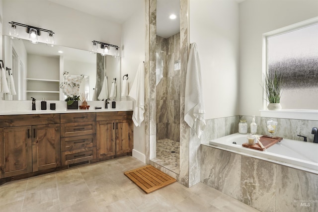 bathroom featuring tile patterned floors, vanity, and separate shower and tub