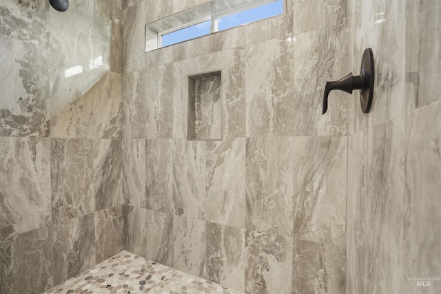 bathroom with a tile shower