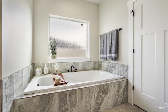 bathroom featuring tiled bath