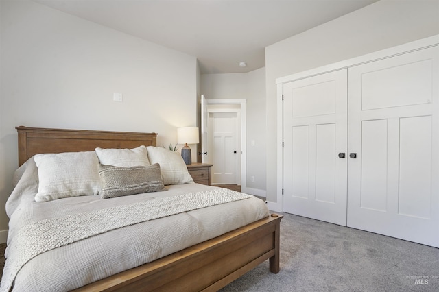 bedroom featuring a closet and light colored carpet